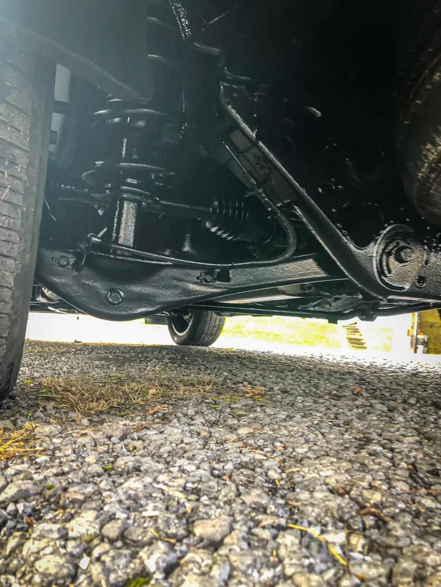 Coated front suspension and control arms after mobile undercoating service