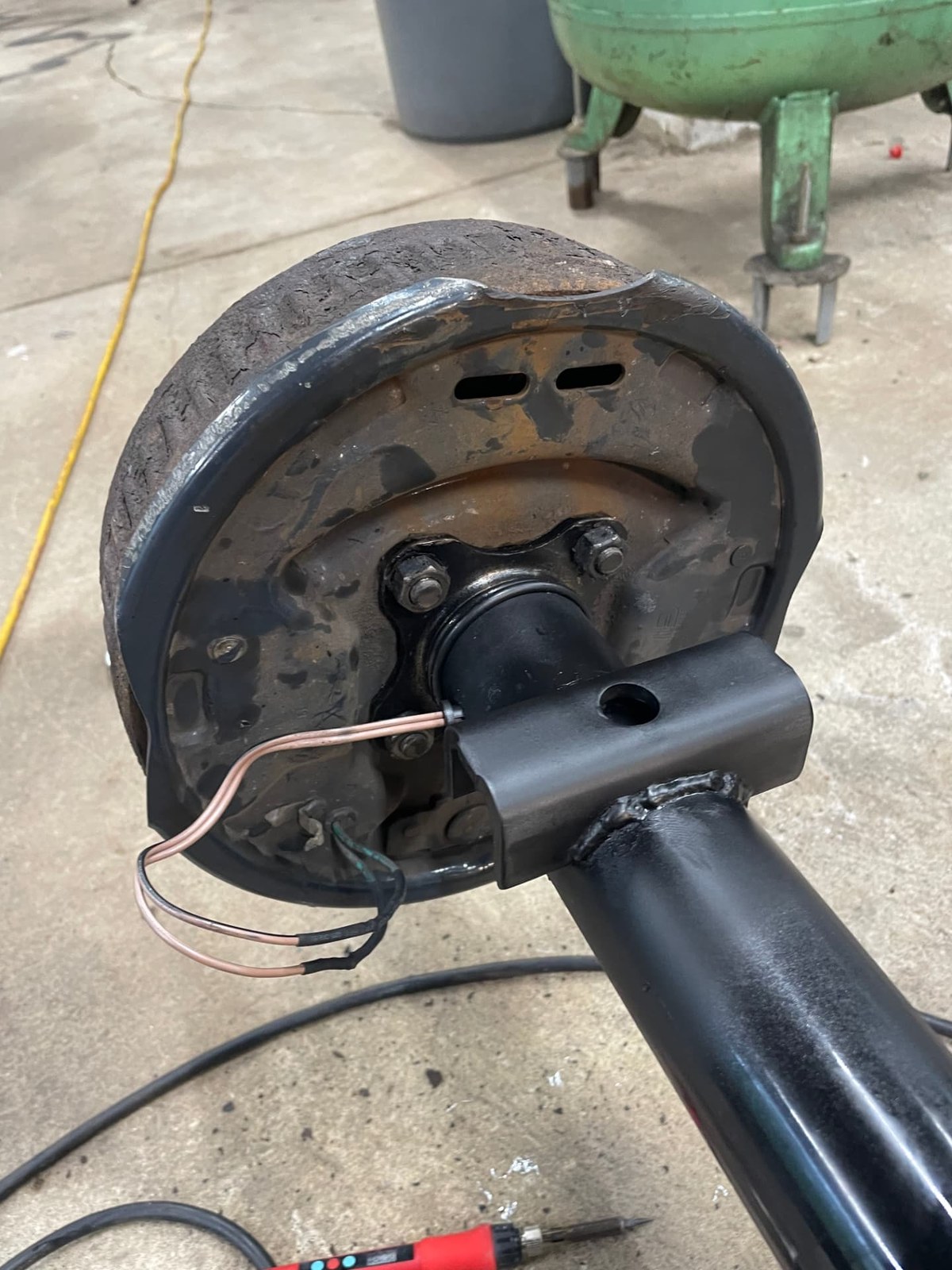 Trailer brake drum and hub assembly with a newly welded mounting bracket
