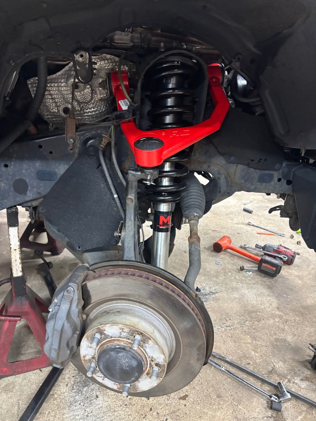 Toyota Tundra front suspension with a new Rough Country lift kit control arm and strut installed