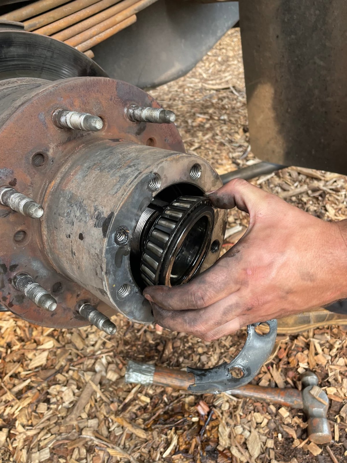 New wheel bearing being installed into a truck hub assembly during an on-site repair